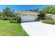 Spacious two-car garage with a white door and bright white driveway at 7023 Woodside Oaks Cir # 1, Sarasota, FL 34231