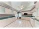 Traditional kitchen with white cabinets, tiled floor, and a ceiling fan at 7023 Woodside Oaks Cir # 1, Sarasota, FL 34231