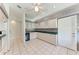 Traditional kitchen featuring white appliances, tile flooring, and plenty of cabinet space at 7023 Woodside Oaks Cir # 1, Sarasota, FL 34231