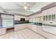 Traditional kitchen with white appliances, and a ceiling fan at 7023 Woodside Oaks Cir # 1, Sarasota, FL 34231