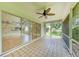 View of the tiled lanai with sliding glass doors leading to the interior at 7023 Woodside Oaks Cir # 1, Sarasota, FL 34231
