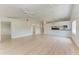 Spacious living room with wood flooring, ceiling fan and bright neutral paint colors at 7023 Woodside Oaks Cir # 1, Sarasota, FL 34231