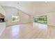 Bright living room with vaulted ceiling and sliding glass doors at 7023 Woodside Oaks Cir # 1, Sarasota, FL 34231
