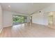 Living room with wood floors, recessed lighting, ceiling fan, and sliding glass doors leading to the patio at 7023 Woodside Oaks Cir # 1, Sarasota, FL 34231