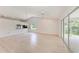Bright living room featuring wood floors, vaulted ceiling, ceiling fan, and a pass-through to the kitchen area at 7023 Woodside Oaks Cir # 1, Sarasota, FL 34231