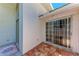 Enclosed patio with terracotta tiling at 7023 Woodside Oaks Cir # 1, Sarasota, FL 34231
