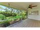 Enjoy the screened porch with ceiling fan overlooking a lush backyard garden at 7023 Woodside Oaks Cir # 1, Sarasota, FL 34231