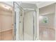 Bathroom with tiled shower, glass doors and view to bedroom at 7023 Woodside Oaks Cir # 1, Sarasota, FL 34231