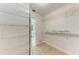 Spacious walk-in closet with ample shelving and neutral walls at 7023 Woodside Oaks Cir # 1, Sarasota, FL 34231