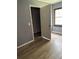 Bedroom featuring laminate flooring, a walk-in closet with shelves, and a window at 7109 28Th E St, Sarasota, FL 34243