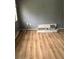 Vacant room showcasing laminate flooring, an electrical outlet, and boxes by the wall at 7109 28Th E St, Sarasota, FL 34243