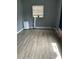 Laminate floored room shows a window and a portable AC unit with a white body at 7109 28Th E St, Sarasota, FL 34243
