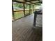 A covered wooden deck featuring wooden railings and partial views of the backyard at 7109 28Th E St, Sarasota, FL 34243