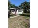 Charming single-story home with a bright red front door and a well-maintained lawn at 7109 28Th E St, Sarasota, FL 34243