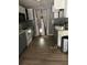 A dated kitchen with a stove, white cabinets, a doorway and a stainless steel trashcan at 7109 28Th E St, Sarasota, FL 34243