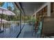 Inviting back porch with seating, dining area, and views of lush greenery at 7251 Fish Farm Rd, Palmetto, FL 34221