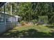 Well-maintained backyard with flourishing garden, patio, and landscaped flowerbeds at 7251 Fish Farm Rd, Palmetto, FL 34221