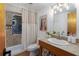 Bathroom with walk-in shower, wood vanity, and stylish light fixture at 7251 Fish Farm Rd, Palmetto, FL 34221