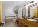 Well-lit bathroom with a double sink vanity, soaking tub, and travertine floors at 7251 Fish Farm Rd, Palmetto, FL 34221