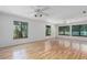 Bonus room features hardwood floors and large windows with treed view at 7251 Fish Farm Rd, Palmetto, FL 34221