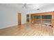 Large, open bonus room features hardwood floors, a ceiling fan, and a balcony at 7251 Fish Farm Rd, Palmetto, FL 34221
