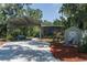 Spacious carport with a shed, and outdoor patio perfect for entertaining, surrounded by green trees at 7251 Fish Farm Rd, Palmetto, FL 34221
