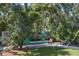 A turquoise chicken coop, set among lush greenery in a tranquil yard at 7251 Fish Farm Rd, Palmetto, FL 34221