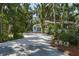 The driveway on the property leads to a white building with a carport at 7251 Fish Farm Rd, Palmetto, FL 34221