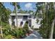 Charming two-story home featuring a welcoming front porch and lush, mature landscaping at 7251 Fish Farm Rd, Palmetto, FL 34221