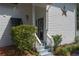 Front entrance featuring a well-maintained garden, steps leading to a covered porch, and stylish exterior details at 7251 Fish Farm Rd, Palmetto, FL 34221