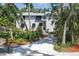 Front exterior of home showing a white gravel driveway surrounded by mature trees and landscaping at 7251 Fish Farm Rd, Palmetto, FL 34221
