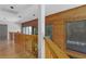 Upper hallway features wood railing and wood paneled walls with large windows at 7251 Fish Farm Rd, Palmetto, FL 34221
