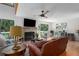 Spacious living room featuring a fireplace, hardwood floors, and ample natural light at 7251 Fish Farm Rd, Palmetto, FL 34221