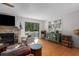 Cozy living room with fireplace, wood floors, and sliding glass doors at 7251 Fish Farm Rd, Palmetto, FL 34221