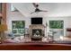 Bright living room with stone fireplace, wood floors, and sliding doors to a private balcony at 7251 Fish Farm Rd, Palmetto, FL 34221