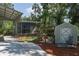 Property featuring multiple outbuildings including a shed, shaded area, and carport at 7251 Fish Farm Rd, Palmetto, FL 34221
