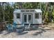 A cozy shed with a modern design, including four chairs and a fire pit, perfect for relaxation at 7251 Fish Farm Rd, Palmetto, FL 34221