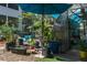 The yard has a variety of different plants, a trellis, a greenhouse, and seating at 7251 Fish Farm Rd, Palmetto, FL 34221