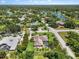 Aerial view of a neighborhood surrounded by mature trees and a nearby lake at 7321 Hemlock Ln, Sarasota, FL 34241
