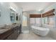 Modern bathroom with double sink vanity, soaking tub, and walk-in shower at 7321 Hemlock Ln, Sarasota, FL 34241