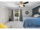 This bedroom features a ceiling fan, closet, carpet, and access to a pool area via a sliding glass door at 7321 Hemlock Ln, Sarasota, FL 34241