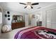 Bedroom with dresser, full-length mirror, ceiling fan, carpet, and closet space at 7321 Hemlock Ln, Sarasota, FL 34241