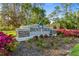 Bent Tree community sign surrounded by colorful flowers and greenery at 7321 Hemlock Ln, Sarasota, FL 34241