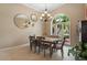 Cozy dining area with a chandelier, arched window, and seating for six at 7321 Hemlock Ln, Sarasota, FL 34241