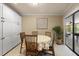 Charming dining area with white cabinets, light tile, and decorative wall art at 7321 Hemlock Ln, Sarasota, FL 34241