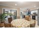 Eat-in kitchen with a view of the screened lanai, white cabinetry, and modern appliances at 7321 Hemlock Ln, Sarasota, FL 34241