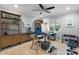 Comfortable home office with glass desk, shelving, weights, and natural light at 7321 Hemlock Ln, Sarasota, FL 34241