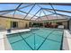 Inviting screened pool area with spa, outdoor kitchen, and spacious lounging areas at 7321 Hemlock Ln, Sarasota, FL 34241
