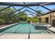 Beautiful pool and spa in a screened-in enclosure with lush landscaping at 7321 Hemlock Ln, Sarasota, FL 34241