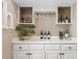 Clean, bright wet bar with white cabinets, white countertop, and convenient storage at 7321 Hemlock Ln, Sarasota, FL 34241